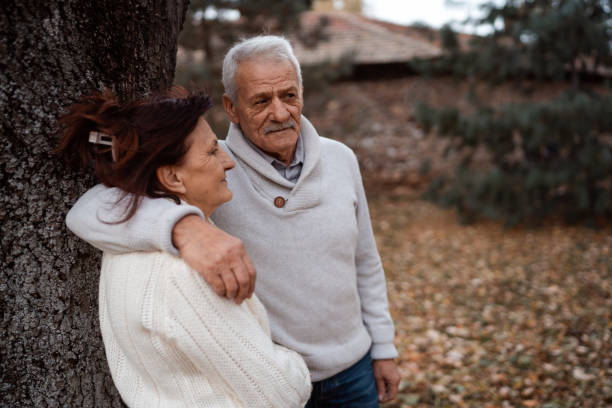 istock Romantic couple in autumn park 1279449322