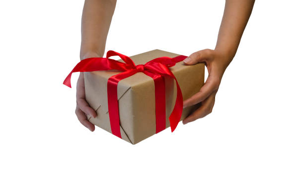 istock hands hold gift box with red ribbon 1279449354
