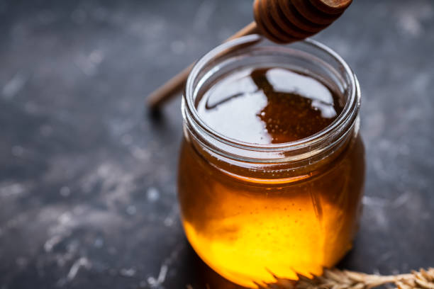 istock Jar with freshly harvested liquid honey on the old wooden table 1279451396