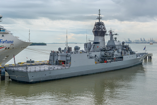 Navy frigate enters a harbour after offshore training exercises.