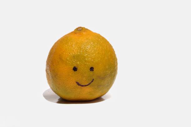 istock Happy Face Drawn on Orange Fruit Isolated on White Background with Copy Space 1279452971