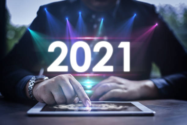 istock Digital infographic celebration 2021 year concept. Businessman uses a smart pad with a virtual screen and popup 2021 text. 1279453320