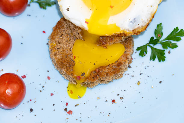 Close up - cut out egg pouring on toast