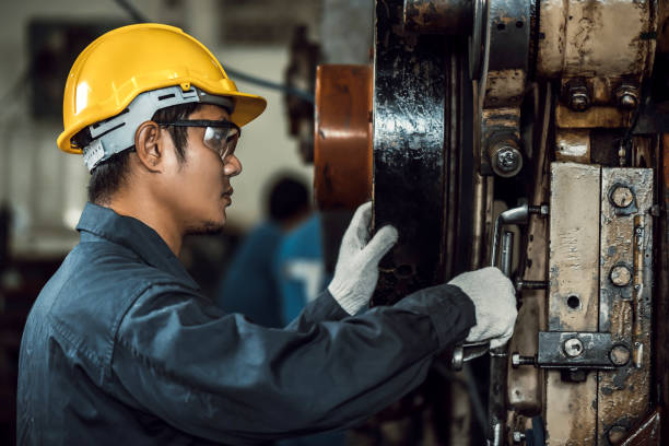 istock Asian engineer mechanic man checking and using wrench for maintenance pressing metal machine at factory, worker at industrial working concept 1279454525