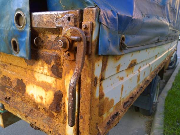 istock Old rusty truck body. Messy metal surface. Damaged grunge texture from road salt. Rust background. Protection car concept. Professional service. Paint work. Lorry. Сorrosion resistance concept. Lock. 1279454864