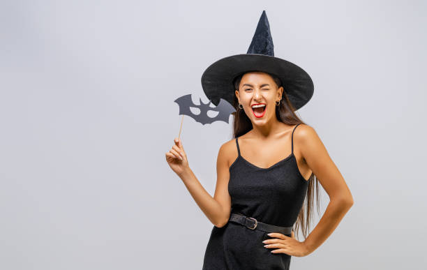 istock Two young women in black witch costumes 1279455412