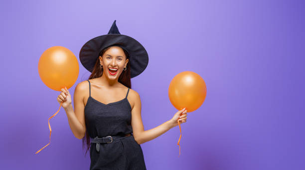istock Two young women in black witch costumes 1279455417