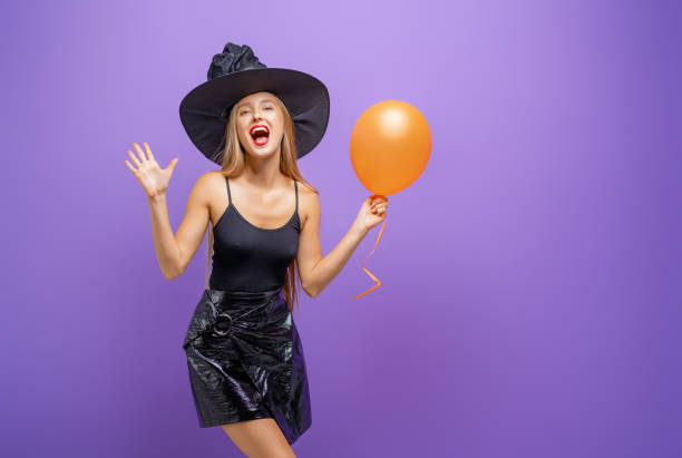 istock Two young women in black witch costumes 1279455454