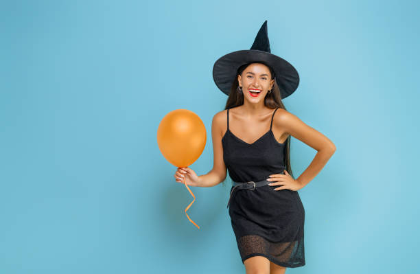 istock Two young women in black witch costumes 1279455501