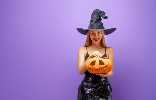 istock Two young women in black witch costumes 1279455582