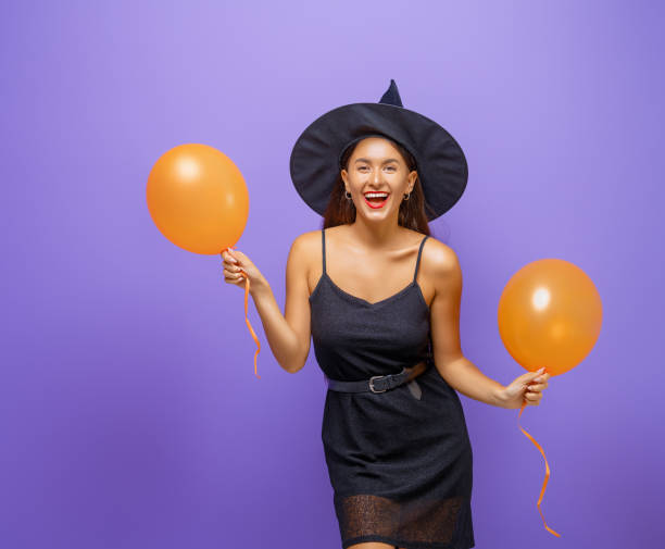 istock Two young women in black witch costumes 1279455619