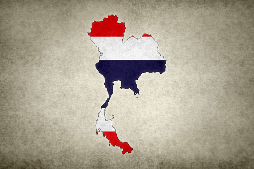 Grunge map of Thailand with its flag printed within its border on an old paper.