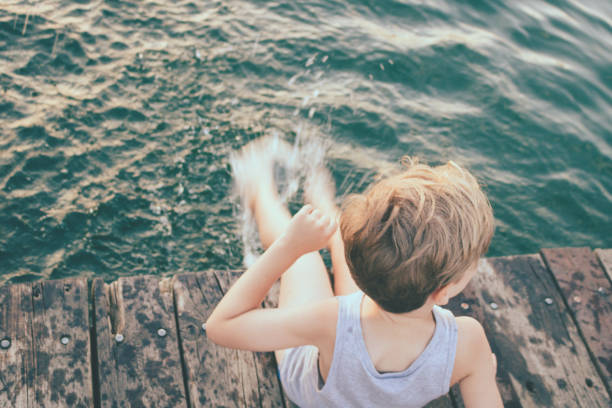 istock Above view of kid splashing water on a pier. 1279458737