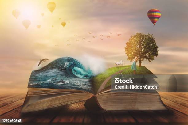 Concept Of An Open Magic Book Open Pages With Water And Land And Small Child Fantasy Nature Or Learning Concept With Copy Space Stock Photo - Download Image Now
