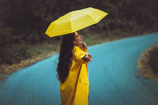 istock Woman holding an Umbrella  in Autumn Colored Forest 1279462949