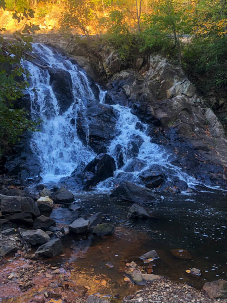 istock Waterfall at sunset autumn foliage background 1279463219
