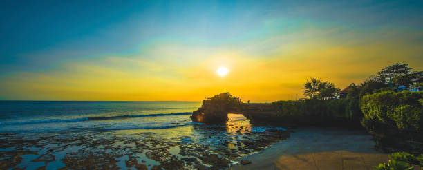 Bali Water Temple at sunset Beautiful Tanah Lot Hindu temple in Bali at sunset tanah lot sunset stock pictures, royalty-free photos & images