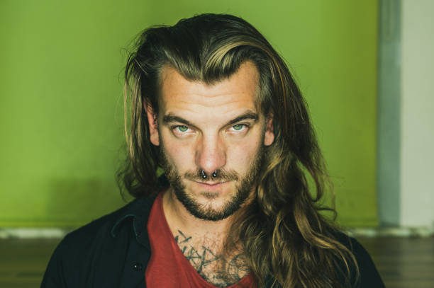istock Man with long hair looks seriously at the camera 1279466786