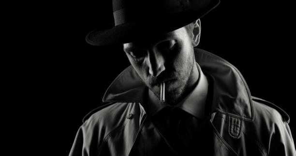 istock Noir film detective posing in the dark 1279470633