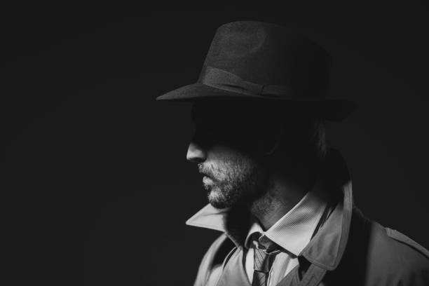 istock Noir film detective posing in the dark 1279471657