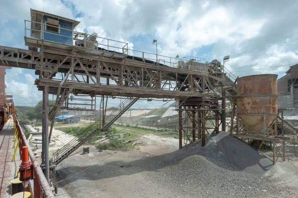 istock Loading of ship cargo gold with bulk cargo bauxite. Dusty atmosphere. 1279471731
