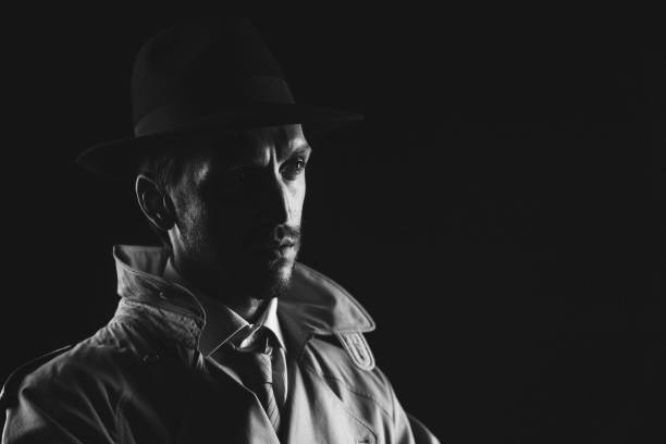istock Noir film detective posing in the dark 1279471814