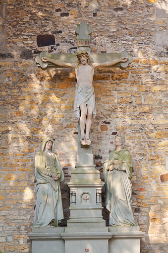 Jesus Christ at cross of wall of cathedral Osnabrueck  in inner courtyard of Dom St Petrus