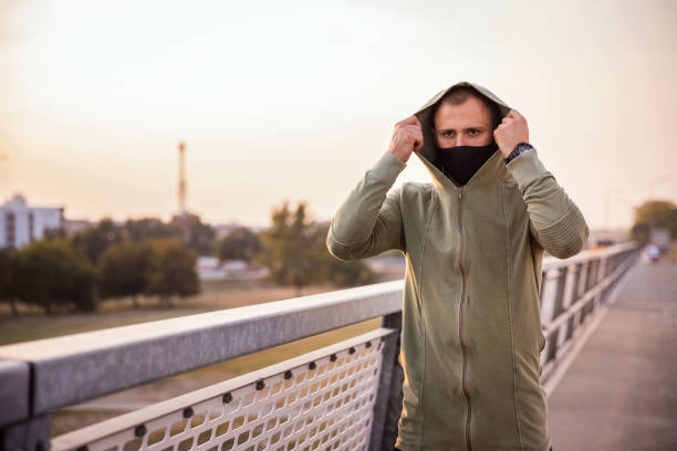 istock Man with protective mask preparing for a jog outdoors 1279478195