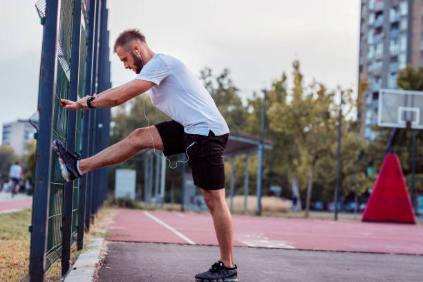 istock Man doing exercises against the fence wall 1279478212