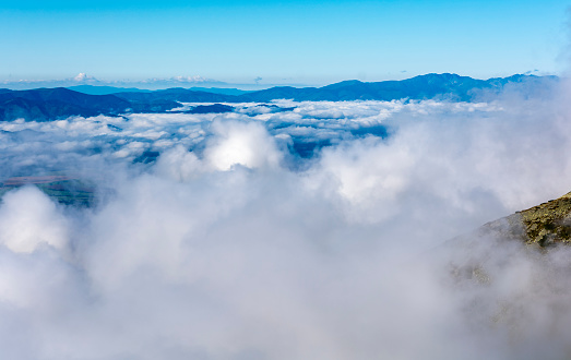 The so-called sea of clouds above the lowlands, and above them emerging mountain ranges.