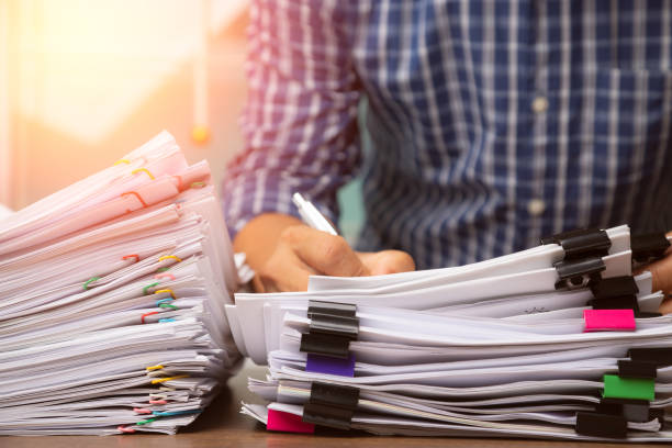 istock Business man pick up Stack overload document report paper, business concept 1279478889