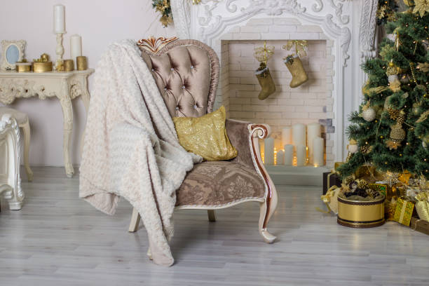 istock Room interior decorated with Christmas tree, arm chair and fireplace 1279479135