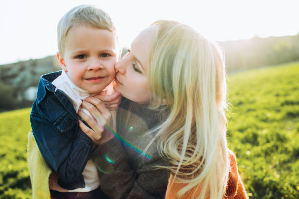 istock Mother is playing with her baby on green grass. 1279479298