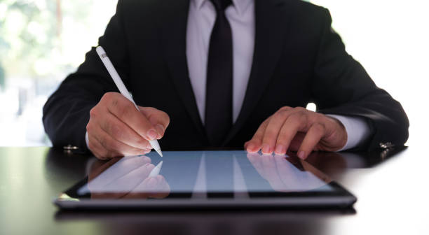 istock Businessman Signing Digital Contract On Tablet Using Stylus Pen 1279479401