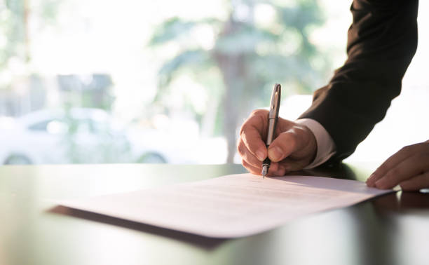 Businessman Signing Contract or Legal Papers stock photo