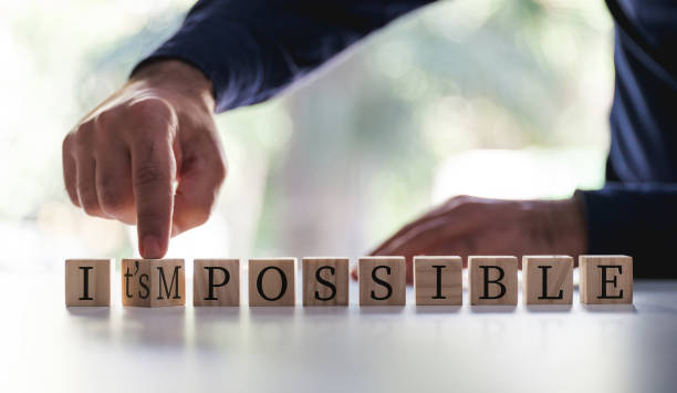 istock Businessman Changing The Word Impossible To Possible By Flipping Over Wooden Cube. 1279481385