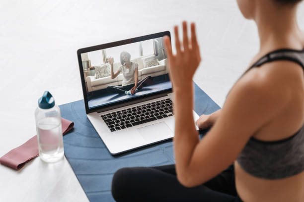 istock Yoga teacher conducting a virtual class on laptop 1279485940