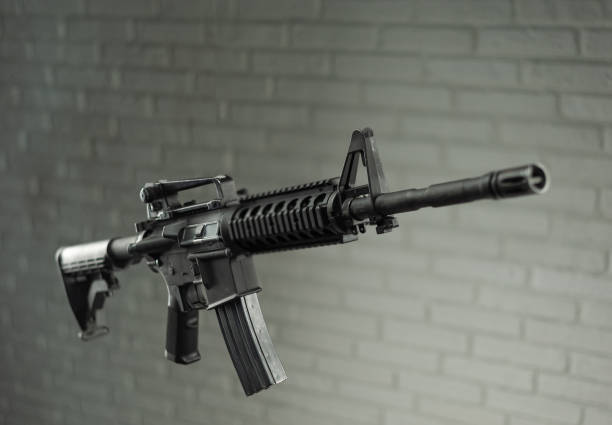 istock American army rifle M4A1 against a brick wall 1279488680