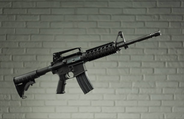 istock American army rifle M4A1 against a brick wall 1279488684