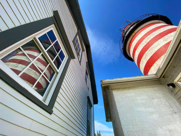 West Quoddy Head Lighthouse in Lubec, Maine  USA West Quoddy Head, in Quoddy Head State Park, Lubec, Maine, is the easternmost point of the contiguous United States. In 1808 a lighthouse was constructed at the site to guide ships through the Quoddy Narrows. The current tower, with distinctive red-and-white stripes, was constructed in 1858 and is an active aid to navigation. The 3rd order Fresnel lens is the only 3rd order and one of only eight Fresnel lenses still in use on the Maine Coast tartrf quoddy head state park stock pictures, royalty-free photos & images