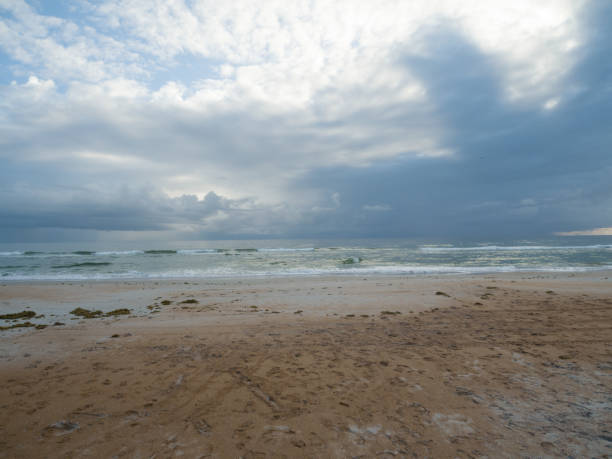 istock Ormond Beach at sunrise with colorful clouds sand and ocean 1279490352