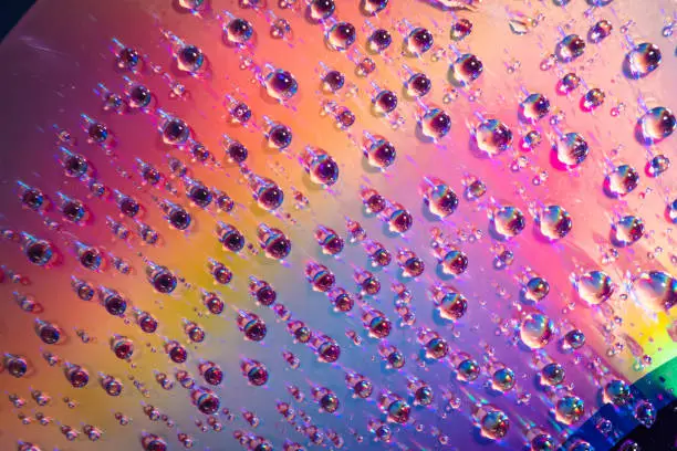 Photo of water drops on dvd media, water drops on colorful background