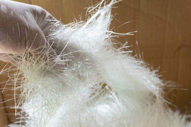 white fiber glass chopper mat stand on his hand - fibra de vidro imagens e fotografias de stock