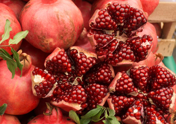 istock Ripe red pomegranates on the market counter 1279497269