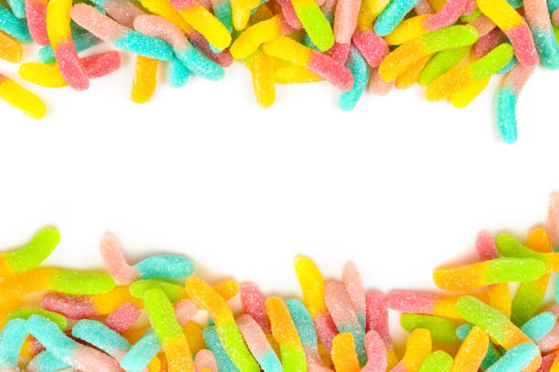 istock Frame of assorted gummy candies isolated on white. Top view. Space for text or design. 1279497788