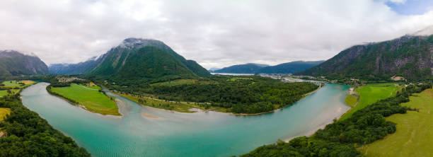 Aerial drone view of Rauma river, mountains and Andalsnes city Wonderful aerial drone view of Rauma river, mountains and Andalsnes city more og romsdal county stock pictures, royalty-free photos & images