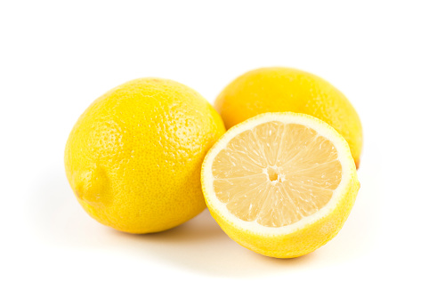 Close-up of cut lemon isolated on white background.