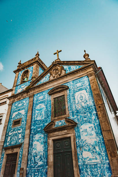 The Famous Chapel of Souls in Porto, Portugal, During Sunset Chapel of Souls, also known as Chapel of Santa Catarina is located in the civil parish of Santo Ildefonso of Porto. The building was constructed in the XVIII century. The external walls were covered with blue-white ceramic tiles depicting episodes like Death of Saint Francis of Assisi and the Martyrdom of Santa Catarina by Eduardo Leite in 1929. The two-story bell tower on the left side of the building is separated by a pillar and covered by a dome. The chapel was classified as Property of Public Interest in 1993. walking point of view stock pictures, royalty-free photos & images