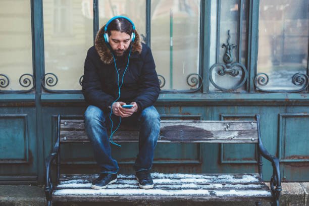 Business man resting at cafe and listening music using vintage headphones