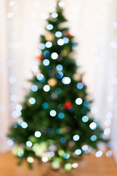 istock Defocused christmas tree silhouette with blurred lights 1279502696